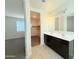 Main bathroom featuring double sinks, and a walk-in closet at 1075 W Avalon Canyon Dr, Casa Grande, AZ 85122