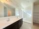 Bathroom featuring double sinks, large mirrors, and a walk-in shower at 1075 W Avalon Canyon Dr, Casa Grande, AZ 85122