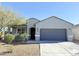 Charming single-story home featuring desert landscaping, gray exterior, and a two-car garage at 1075 W Avalon Canyon Dr, Casa Grande, AZ 85122