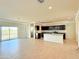 Open-concept kitchen and living room with dark cabinetry, white countertops, and tile floors at 1075 W Avalon Canyon Dr, Casa Grande, AZ 85122