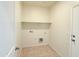 Laundry room with tile floors, a shelf, and light walls at 1075 W Avalon Canyon Dr, Casa Grande, AZ 85122