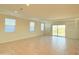 Spacious living room with tile flooring, modern lighting, and a sliding glass door at 1075 W Avalon Canyon Dr, Casa Grande, AZ 85122