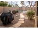 Backyard featuring a stone walkway leading to a pool, and a covered grill at 1119 S Presidio Dr, Gilbert, AZ 85233