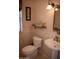 Cozy half bathroom with a pedestal sink, toilet, and decorative wall art at 1119 S Presidio Dr, Gilbert, AZ 85233