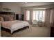 Well-lit bedroom with plush carpet, bay window, pink curtains, and a king-size bed at 1119 S Presidio Dr, Gilbert, AZ 85233