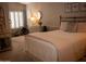 Serene bedroom with neutral tones, plantation shutters, carpet, and accent furniture at 1119 S Presidio Dr, Gilbert, AZ 85233