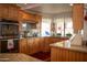 Traditional-style kitchen features wood cabinets, granite countertops, and stainless steel appliances at 1119 S Presidio Dr, Gilbert, AZ 85233