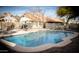 Backyard with a sparkling pool enclosed by a safety fence, and a patio table with umbrella at 1119 S Presidio Dr, Gilbert, AZ 85233