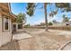 Backyard featuring patio, large tree, and gravel landscaping at 11616 S Jokake St, Phoenix, AZ 85044