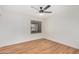 Bright bedroom with wood-look floors and a modern ceiling fan with natural light from the window at 11616 S Jokake St, Phoenix, AZ 85044