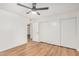 Bedroom featuring wood-look floors, a modern ceiling fan, and a sliding closet door at 11616 S Jokake St, Phoenix, AZ 85044