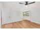 This bedroom features wood-look floors and a modern ceiling fan with a door and window at 11616 S Jokake St, Phoenix, AZ 85044