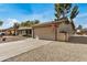 Single-story home featuring a two-car garage, covered entry, and desert landscaping at 11616 S Jokake St, Phoenix, AZ 85044