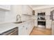 Modern kitchen featuring new appliances, white cabinets, light counters, and a stainless steel sink at 11616 S Jokake St, Phoenix, AZ 85044