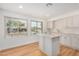 Bright kitchen features tile backsplash, an island, and plenty of natural light at 11616 S Jokake St, Phoenix, AZ 85044