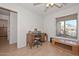 Functional bedroom with hardwood floors and a comfortable workspace with lots of natural light at 12721 W Valentine Ave, El Mirage, AZ 85335