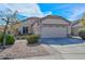 Charming single-story home with a two-car garage, neat landscaping, and an American flag at 12721 W Valentine Ave, El Mirage, AZ 85335