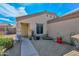 Inviting front exterior with gravel landscaping, small trees, decorative items, and walkway to front door at 12721 W Valentine Ave, El Mirage, AZ 85335