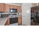 A kitchen featuring wood cabinets, black appliances, and ample counter space at 12721 W Valentine Ave, El Mirage, AZ 85335