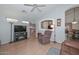 Open living room with wood-look floors, a fireplace, and a built-in bookshelf at 12721 W Valentine Ave, El Mirage, AZ 85335