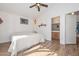 Spacious main bedroom featuring wood-look flooring, ensuite bathroom and a comfortable bed at 12721 W Valentine Ave, El Mirage, AZ 85335