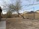 Spacious backyard features a brick wall and string lights at 1298 S 222Nd Ln, Buckeye, AZ 85326