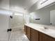 Bright bathroom with tub, shower, tile floor, and wooden vanity with a white countertop at 1298 S 222Nd Ln, Buckeye, AZ 85326