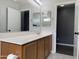 Well lit bathroom featuring double vanity with wooden cabinets and white countertops at 1298 S 222Nd Ln, Buckeye, AZ 85326