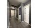 This hallway with modern gray walls, vinyl floors, bright lighting and doorways offers convenient access throughout the home at 1298 S 222Nd Ln, Buckeye, AZ 85326