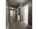 Hallway with modern gray walls, vinyl floors, bright lighting and multiple doorways, creating easy access at 1298 S 222Nd Ln, Buckeye, AZ 85326