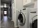 The laundry room includes modern appliances and ample cabinet space for easy organization at 1298 S 222Nd Ln, Buckeye, AZ 85326