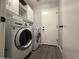 Laundry room features front-loading washer and dryer, upper cabinets, and access to the exterior at 1298 S 222Nd Ln, Buckeye, AZ 85326