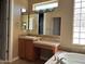 Bathroom showcasing a vanity with granite counters, tiled backsplash, and framed mirror at 13117 W Micheltorena Dr, Sun City West, AZ 85375