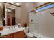 Bathroom with a glass shower enclosure and a large mirror at 13117 W Micheltorena Dr, Sun City West, AZ 85375