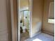 Ensuite bathroom featuring a glass door, a toilet, and a small sink at 13117 W Micheltorena Dr, Sun City West, AZ 85375