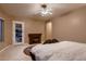 Bedroom features a ceiling fan and a fireplace at 13117 W Micheltorena Dr, Sun City West, AZ 85375