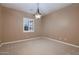 Neutral bedroom with plantation shutters and a decorative light fixture, ready for your personal touch at 13117 W Micheltorena Dr, Sun City West, AZ 85375