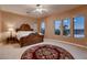 Bedroom with large windows, a decorative rug, and great backyard views at 13117 W Micheltorena Dr, Sun City West, AZ 85375