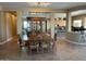 Elegant dining area with a large table and views of the kitchen, perfect for Gathering gatherings at 13117 W Micheltorena Dr, Sun City West, AZ 85375