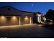 Inviting home exterior at dusk features a multi-car garage and professionally landscaped yard at 13117 W Micheltorena Dr, Sun City West, AZ 85375