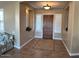 Elegant foyer featuring tile floors, a decorative rug, and a wooden front door with sidelights at 13117 W Micheltorena Dr, Sun City West, AZ 85375