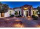 Attractive single-story residence featuring desert landscaping, walkway lighting, and a stone accented entry at 13117 W Micheltorena Dr, Sun City West, AZ 85375