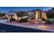 Inviting single-story home with stone accents, lush landscaping, and pathway lighting at 13117 W Micheltorena Dr, Sun City West, AZ 85375