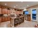 Well-lit kitchen boasting a center island with seating, stainless steel appliances, and granite countertops at 13117 W Micheltorena Dr, Sun City West, AZ 85375