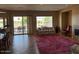 Spacious living room with views of the patio, complemented by a cozy fireplace and ample seating at 13117 W Micheltorena Dr, Sun City West, AZ 85375