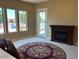 Relaxing main bedroom featuring an electric fireplace, pool views, and a stylish area rug at 13117 W Micheltorena Dr, Sun City West, AZ 85375