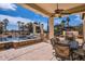 Relaxing patio featuring a built-in grill, seating area, pool, and golf course view, perfect for entertaining at 13117 W Micheltorena Dr, Sun City West, AZ 85375