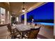 Covered patio area with dining set, overlooking pool and outdoor fire pit in the backyard at 13117 W Micheltorena Dr, Sun City West, AZ 85375