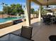 Extended covered patio with outdoor seating, a BBQ, ceiling fan, and pool views at 13117 W Micheltorena Dr, Sun City West, AZ 85375