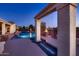 Beautiful backyard pool and spa with fire features and lush landscaping at twilight at 13117 W Micheltorena Dr, Sun City West, AZ 85375